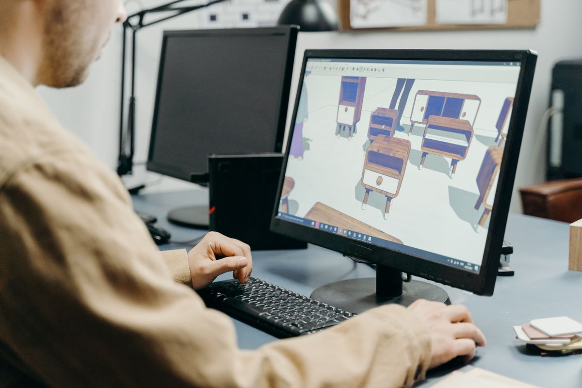 Engineer working on a 3D model at a CAD workstation